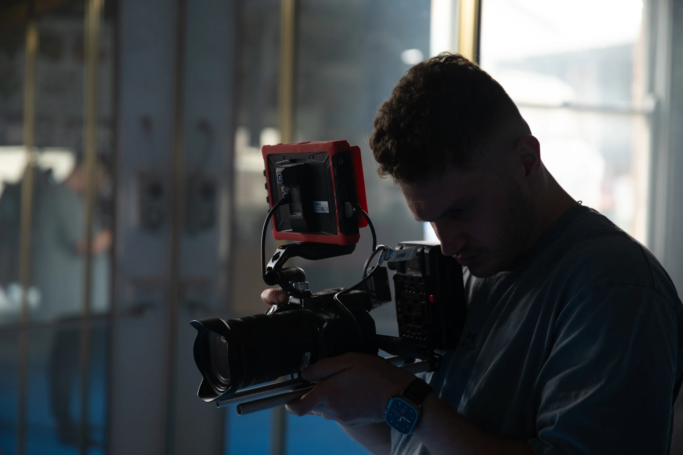 Darian checking camera settings behind the scenes